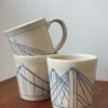 Wheel thrown pottery mugs with bridge motif