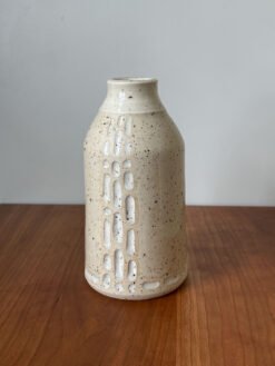 Wheel thrown bottle vase with carved design