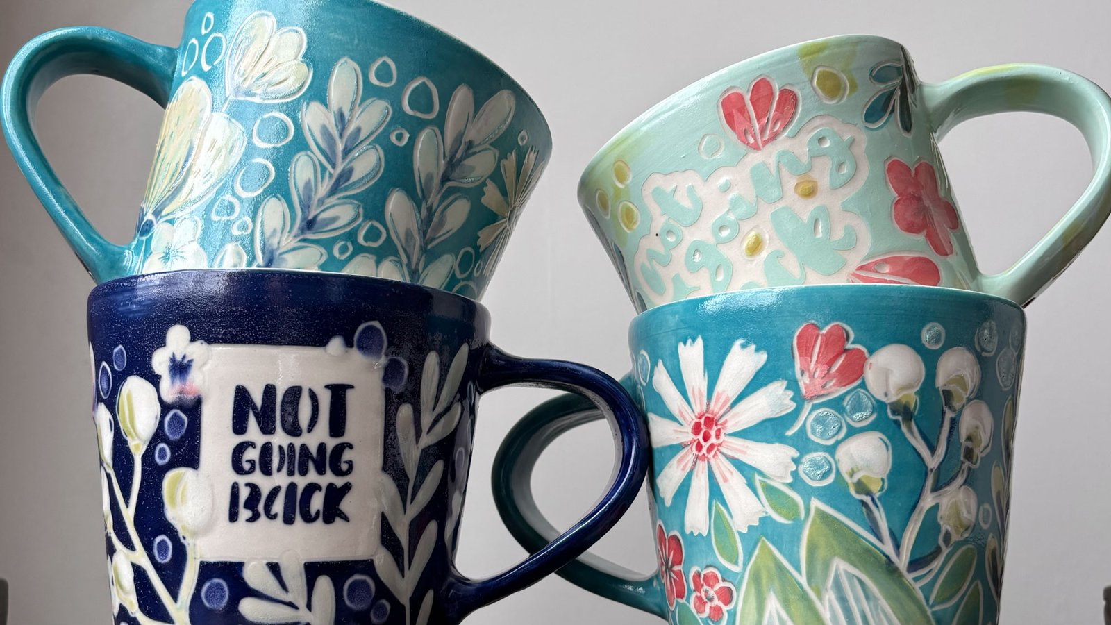 handmade pottery mugs with flower design