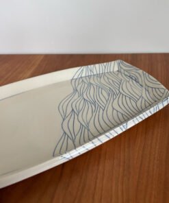 close up of pottery platter with wave pattern